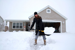 a man riding on the back of a house covered in snow