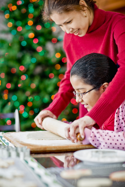 a little girl baking at a table